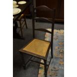 A pair of stained rush seated dining chairs, ladder back, H-stretcher,