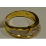 A contemporary two tone yellow and white gold diamond ring, central inverted square cut diamond,