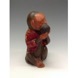 A Bretby model of a bowling monkey, he sits wearing a red jacket and holding a bowl, 17cm high,