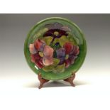 A Moorcroft Anemone pattern circular plate, tube lined with large flowerheads and foliage,
