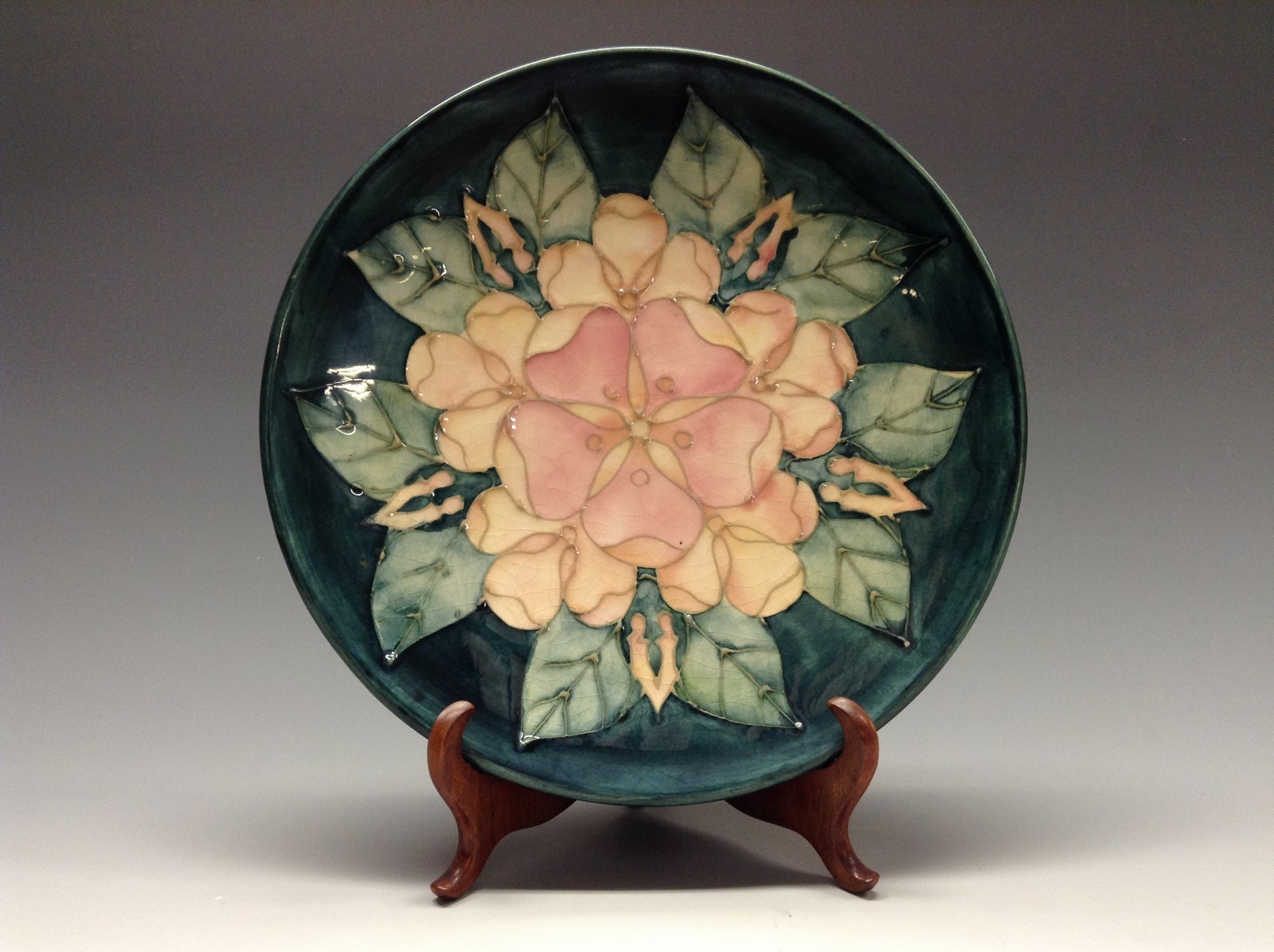 A contemporary Moorcroft plate, tube lined with large flowerhead in tones of pink,