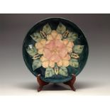 A contemporary Moorcroft plate, tube lined with large flowerhead in tones of pink,