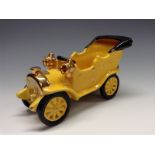 A Bretby novelty model of an early 20th century motor car, yellow glaze,