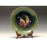 A Moorcroft  Leaf and Berries pattern circular plate, tube lined with large leaves and berries, in