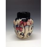 A contemporary Moorcroft ginger jar and cover, tube lined with stylised flowers and foliage,