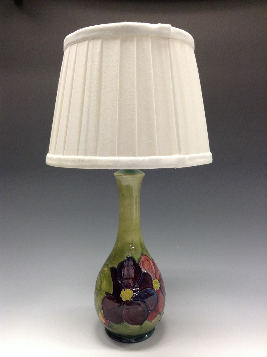 A Moorcroft Clematis pattern table lamp, tube lined with large flowerheads,