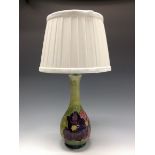 A Moorcroft Clematis pattern table lamp, tube lined with large flowerheads,