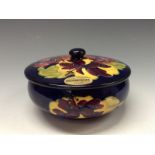 A Moorcroft Hibiscus pattern powder bowl and cover, tube lined with large flowerheads in red,