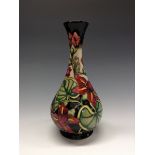 A contemporary Moorcroft  bottle vase, tube lined with large flowers and foliage,