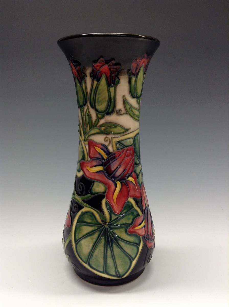 A contemporary Moorcroft waisted cylindrical vase, tube lined with stylised flowers and foliage,