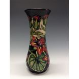 A contemporary Moorcroft waisted cylindrical vase, tube lined with stylised flowers and foliage,