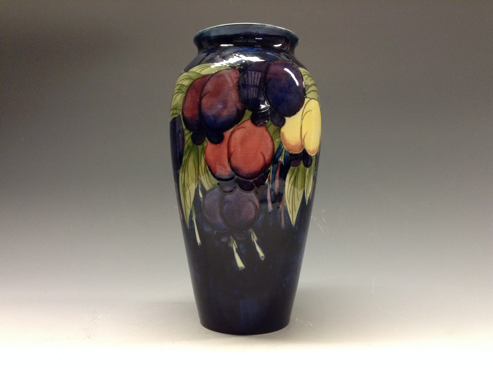 A Moorcroft Wisteria ovoid vase, tube lined with red, purple,