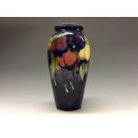 A Moorcroft Wisteria ovoid vase, tube lined with red, purple,