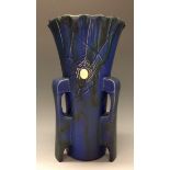 A Bretby three-handled vase, blue vein glaze applied with spiders and webs in slip,