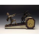 A French Art Deco silvered and dark patinated metal, marble and onyx figural mantel clock,