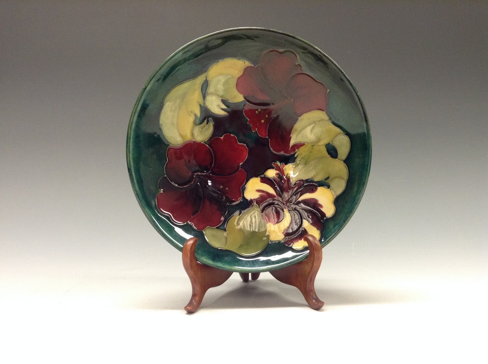 A Moorcroft Hibiscus pattern shallow dish, tube lined with large flowerheads in red,