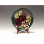 A Moorcroft Hibiscus pattern shallow dish, tube lined with large flowerheads in red,