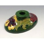 A Moorcroft Hibiscus pattern oval boudoir candlestick,