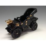 A Bretby novelty model of an early 20th century motor car, black glaze, folded canopy,