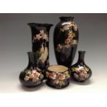 A Bretby Cloisonné ovoid vase, brightly painted with birds by blossoming branches, black ground,