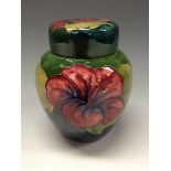 A Moorcroft Hibiscus pattern ginger jar and cover, tube lined with large flowerheads in red,