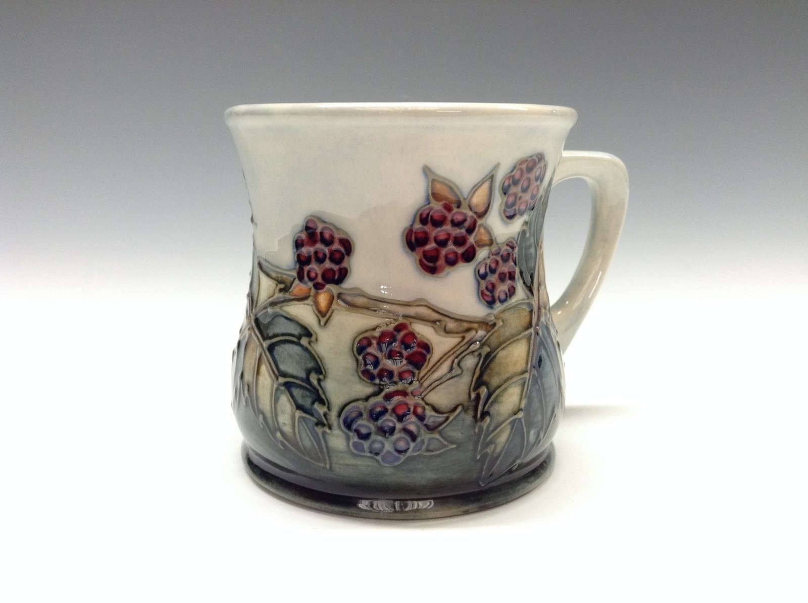 A contemporary Moorcroft Blackberry mug, tube lined with berries and leaves, in autumn tones,  8.