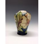 A contemporary Moorcroft tapering cylindrical vase, tube lined with stylised flowers and foliage,