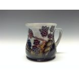 A contemporary Moorcroft Blackberry mug, tube lined with berries and leaves, in autumn tones,  8.
