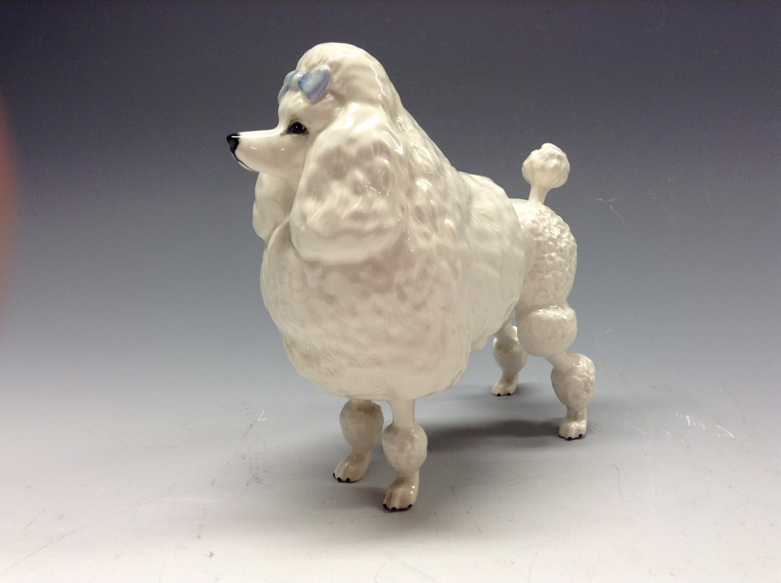 A Beswick model, of a poodle, Ivanola Gold Digger, white gloss, model no. 2108
 Condition Report: