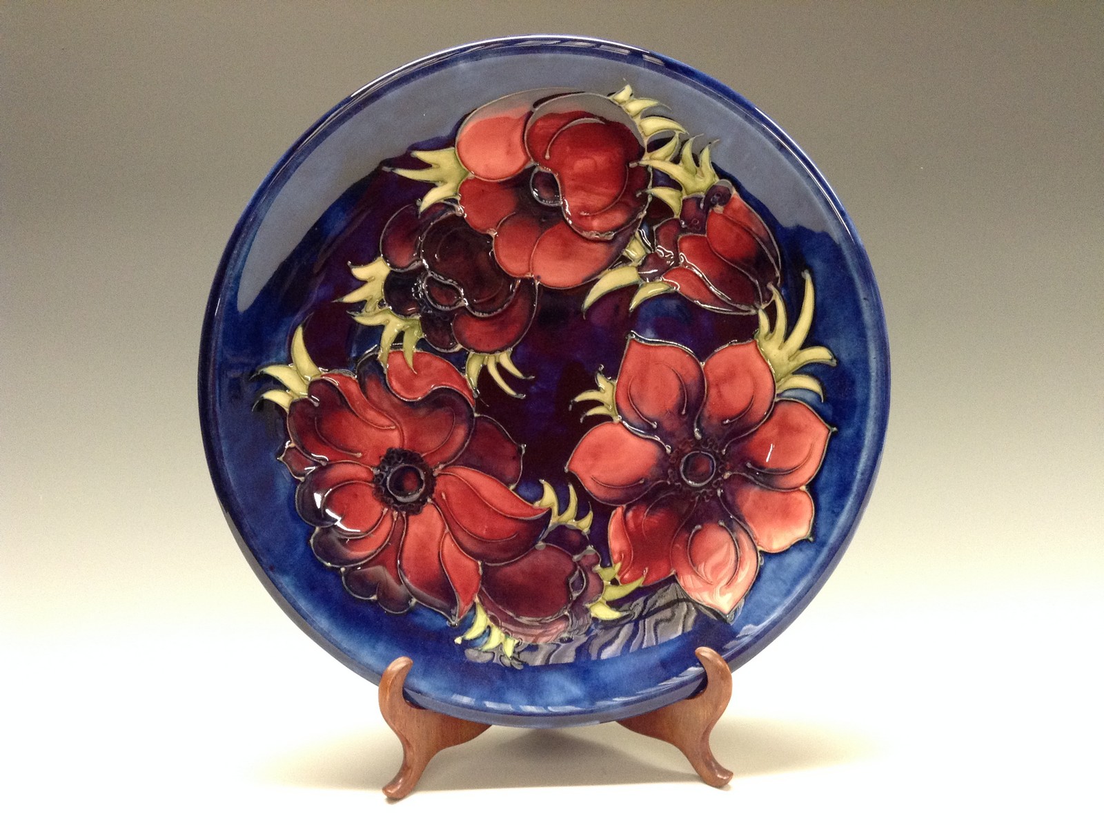 A Moorcroft Anemone pattern circular plate, tube lined with large flowerheads and foliage,