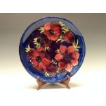 A Moorcroft Anemone pattern circular plate, tube lined with large flowerheads and foliage,