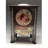 A Liberty type  Arts and Crafts hammered silvered mantel clock, 11.