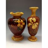 A Bretby Impasto ovoid baluster vase, painted in slip with hellebores on a brown glazed ground,