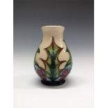 A contemporary Moorcroft Holly and Berries pattern vase,