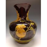 A Bretby baluster vase, moulded with a rat eating berries by a sprouting shoot,