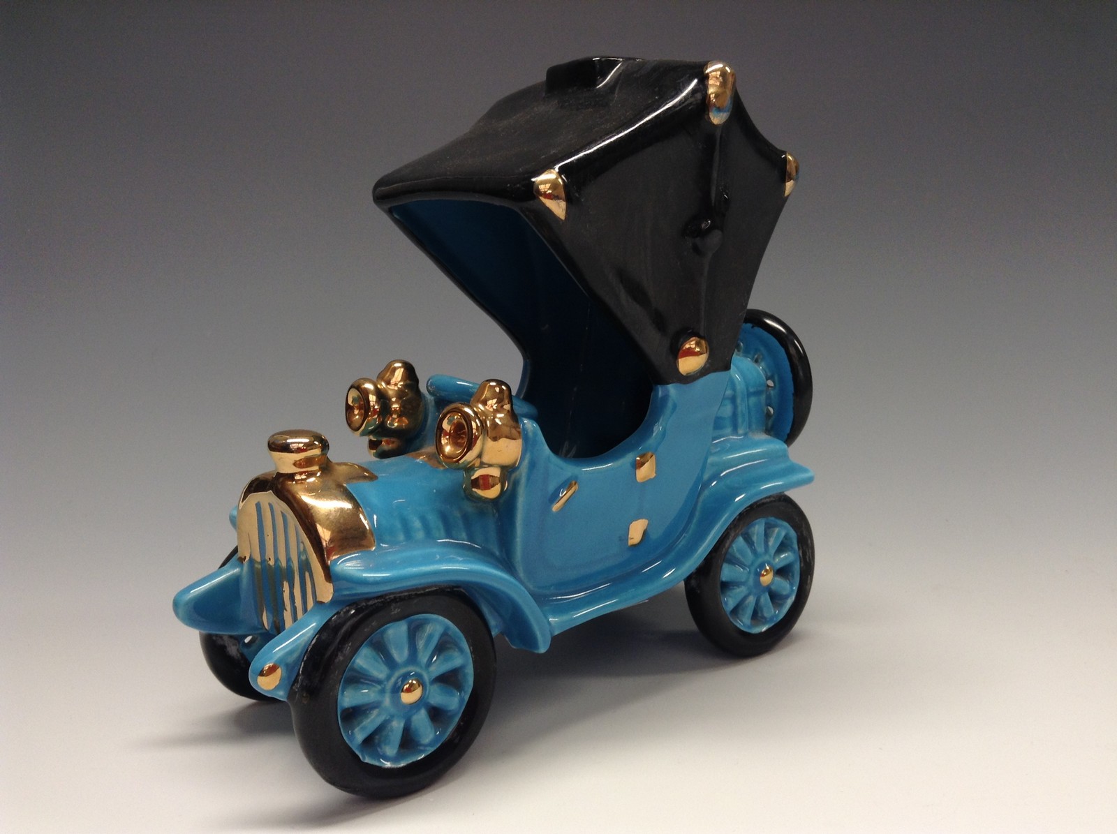 A Bretby novelty model of an early 20th century motor car, light blue glaze, black matt canopy,