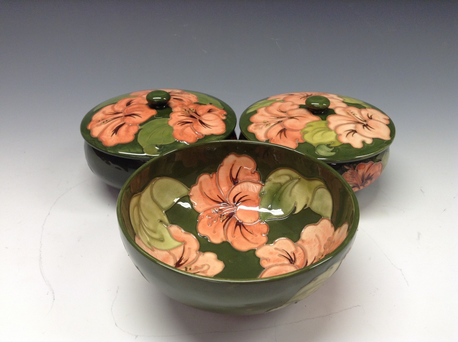 A pair of Moorcroft Hibiscus pattern powder jar and cover,