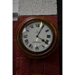 An oak circular station clock, F.Yates, Chesterfield, white dial, Roman numerals, 44cm diameter.