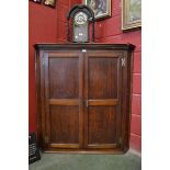 A George III oak splay front corner cabinet,  the moulded dentil cornice,