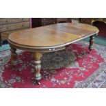 A Victorian mahogany pull-out dining table, with two additional leaves,