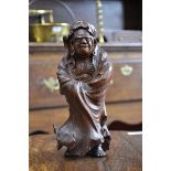 A Japanese carving, of a sage, he stands, wrapped in a cloak, 23cm high,