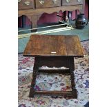 An oak occasional table, square plank top, shaped apron, turned, spreading supports.