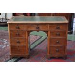 A Victorian kneehole desk, tooled inlaid green leather top,