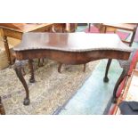 A George II Revival mahogany serpentine serving table, gadrooned top above a long frieze drawer,