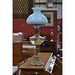 A Victorian oil lamp, clear glass reservoir, cast brass column, decorated with fruiting vines,