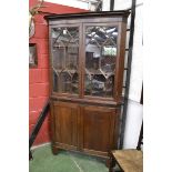 A George III oak and mahogany splay fronted floor standing corner cupboard,
