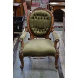 A Victorian walnut spoon back armchair, outswept arms, stuffed over upholstery,
