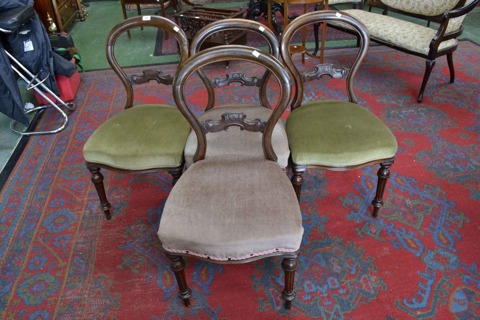 A set of four Victorian walnut balloon back chairs, horizontal shaped splat,