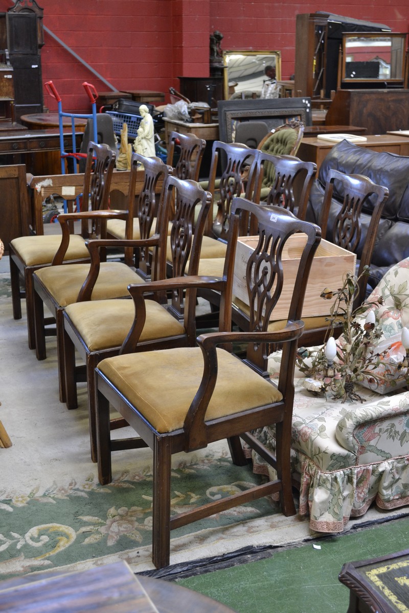 A set of eight Georgian style mahogany dining chairs including two carvers, shaped top rail,