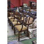 A set of eight Georgian style mahogany dining chairs including two carvers, shaped top rail,